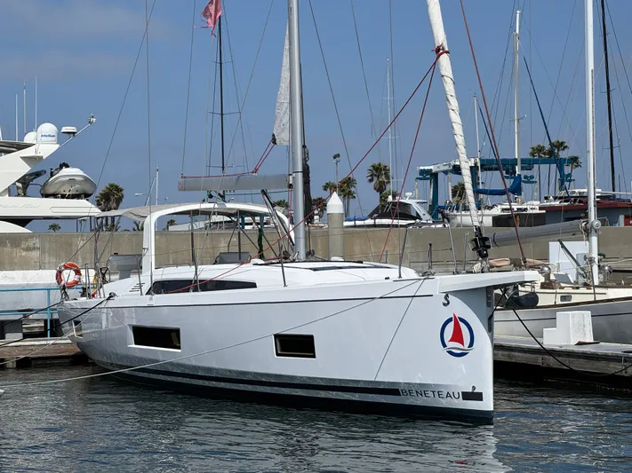 Sensei Yacht Photos Pics 2021 Beneteau Oceanis 46.1 sailboat docked at marina, clear sky background.
