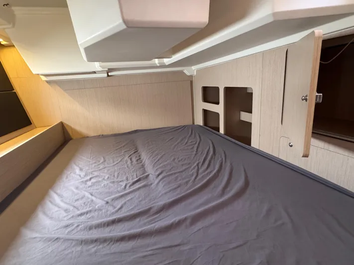 Sensei Yacht Photos Pics Interior cabin of 2021 Beneteau Oceanis 46.1 yacht with bed and storage.