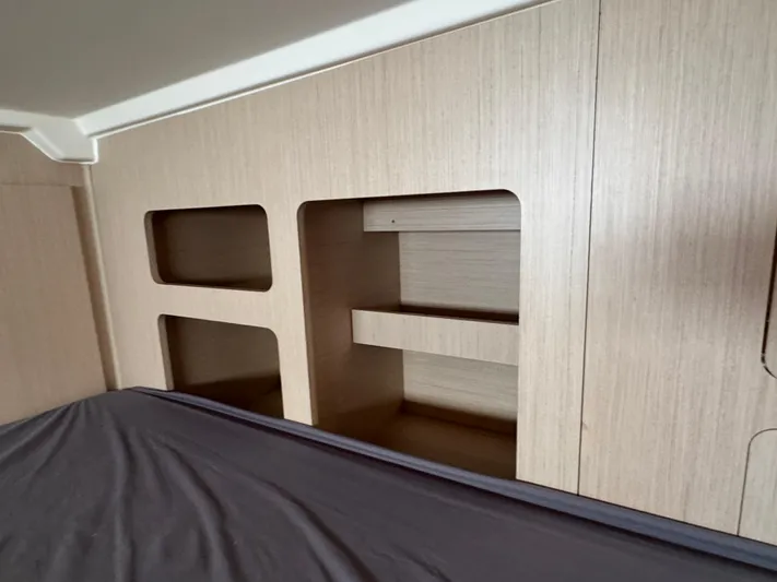 Sensei Yacht Photos Pics Interior shelving of 2021 Beneteau Oceanis 46.1 yacht, featuring light wood finish.