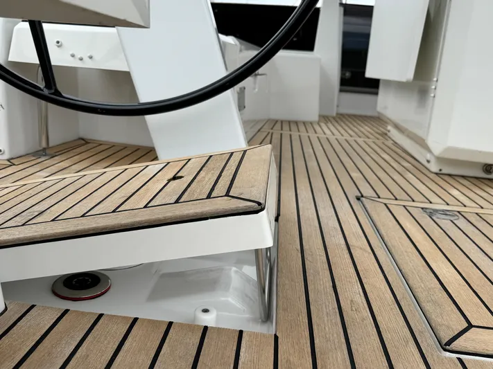 Sensei Yacht Photos Pics Beneteau Oceanis 46.1 2021 yacht deck with sleek wood finish and steering wheel.
