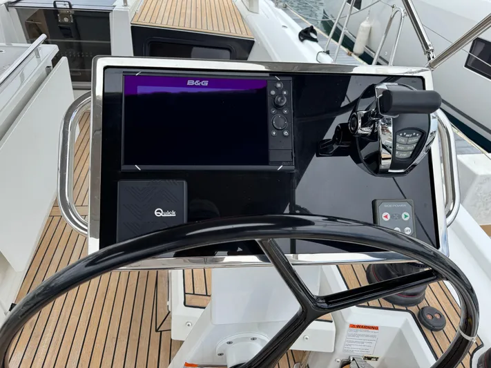 Sensei Yacht Photos Pics Steering console of 2021 Beneteau Oceanis 46.1 yacht with navigation controls.