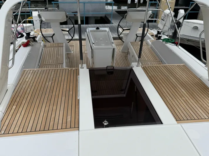 Sensei Yacht Photos Pics Beneteau Oceanis 46.1 yacht deck, 2021 model, featuring dual steering wheels and teak flooring.