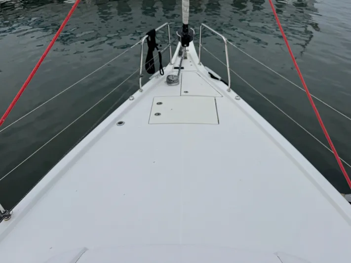 Sensei Yacht Photos Pics Deck view of 2021 Beneteau Oceanis 46.1 sailboat, featuring sleek design and red rigging.