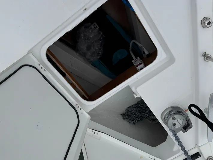 Sensei Yacht Photos Pics Open hatch on 2021 Beneteau Oceanis 46.1 sailboat deck, showing interior storage.