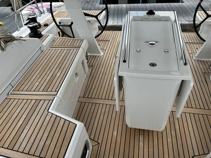 Sensei Yacht Photos Pics Beneteau Oceanis 46.1 yacht deck, featuring sleek wood paneling and modern steering wheels.