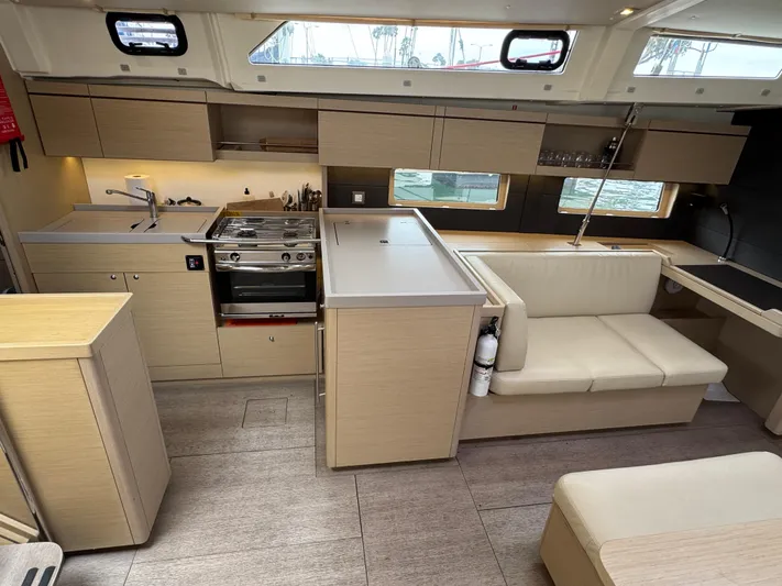 Sensei Yacht Photos Pics Modern interior of 2021 Beneteau Oceanis 46.1 yacht, featuring a sleek kitchen and seating area.