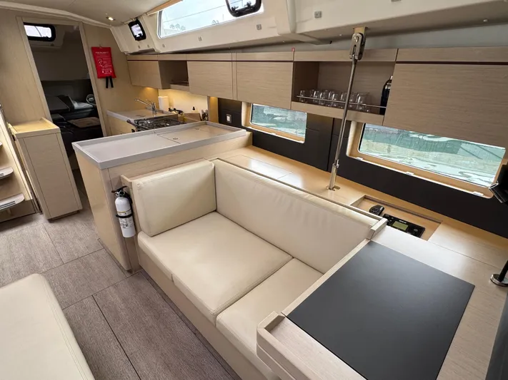 Sensei Yacht Photos Pics Modern interior of 2021 Beneteau Oceanis 46.1 yacht with sleek kitchen and seating area.