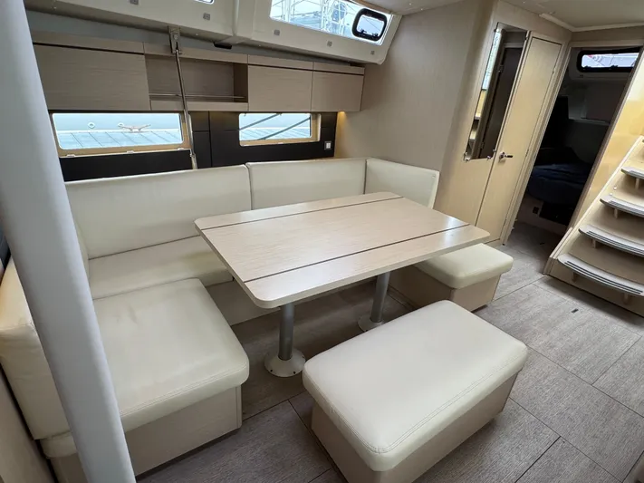 Sensei Yacht Photos Pics Interior of 2021 Beneteau Oceanis 46.1 yacht with modern dining area and light wood finishes.