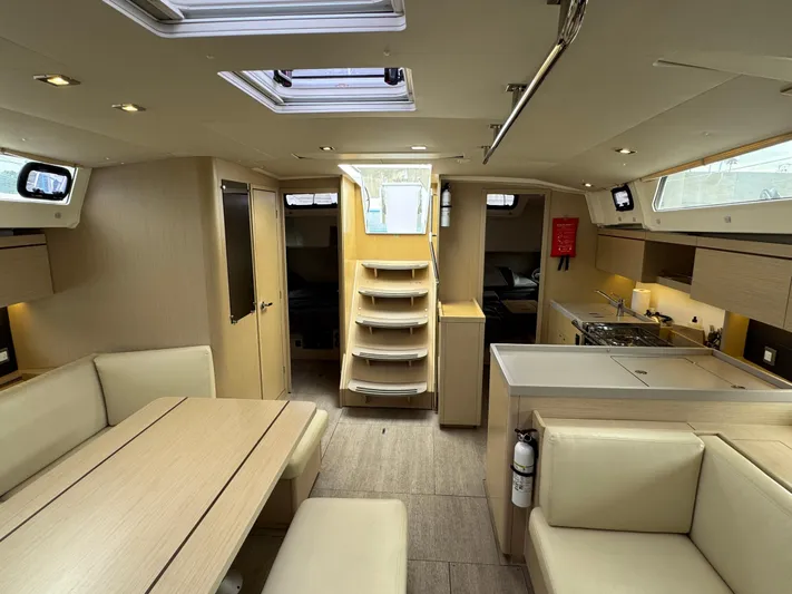 Sensei Yacht Photos Pics Interior of 2021 Beneteau Oceanis 46.1 yacht, featuring modern kitchen and dining area.