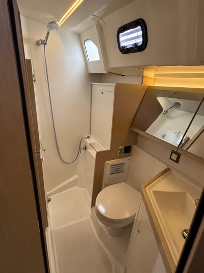 Sensei Yacht Photos Pics Modern bathroom in 2021 Beneteau Oceanis 46.1 yacht, featuring shower, toilet, and sink.