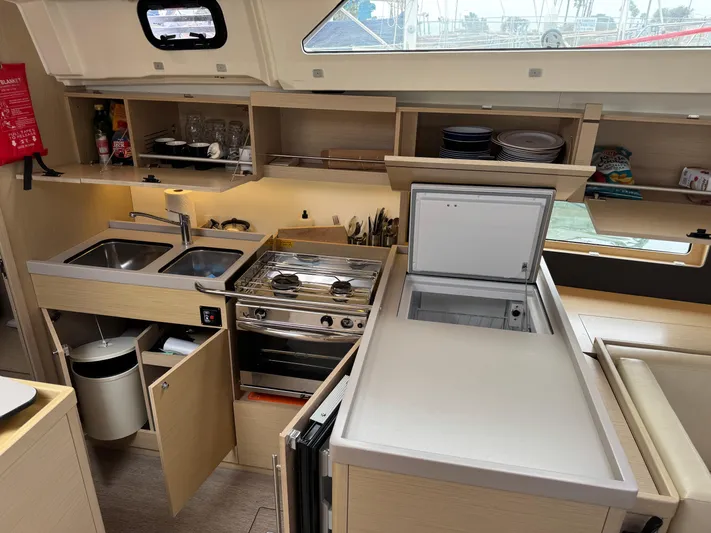 Sensei Yacht Photos Pics Modern kitchen in 2021 Beneteau Oceanis 46.1 yacht with stove, sink, and storage.