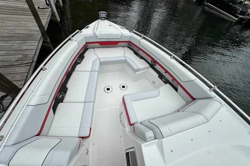  Yacht Photos Pics 2024 Formula 330 CBR boat interior with white and red seating, docked by water.