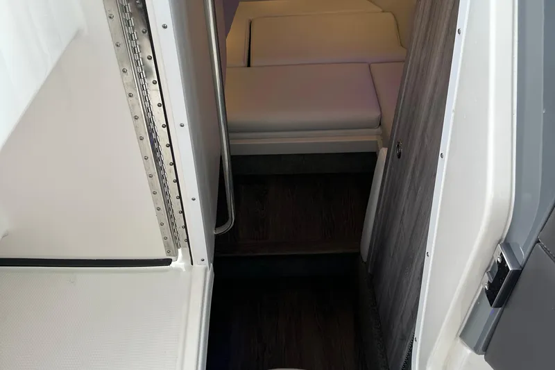  Yacht Photos Pics Interior view of 2024 Formula 330 CBR boat cabin with seating and wood accents.