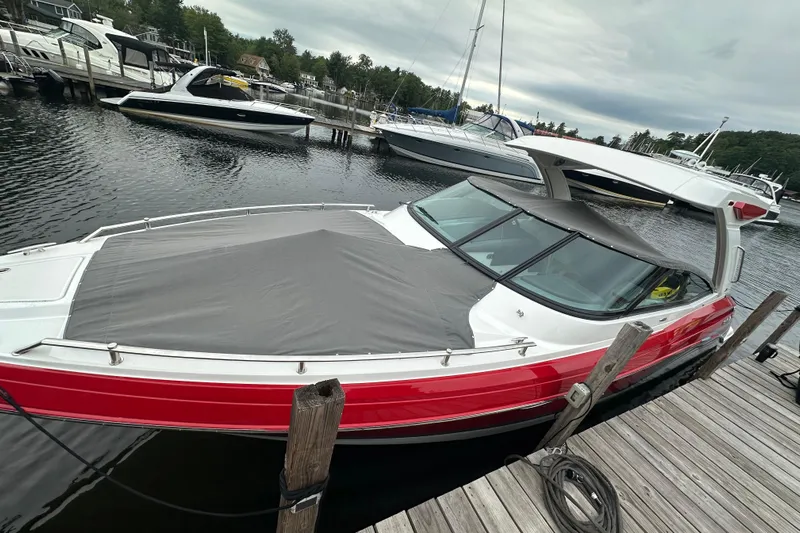  Yacht Photos Pics 2024 Formula 330 CBR boat docked, featuring a sleek red and white design with a covered bow.