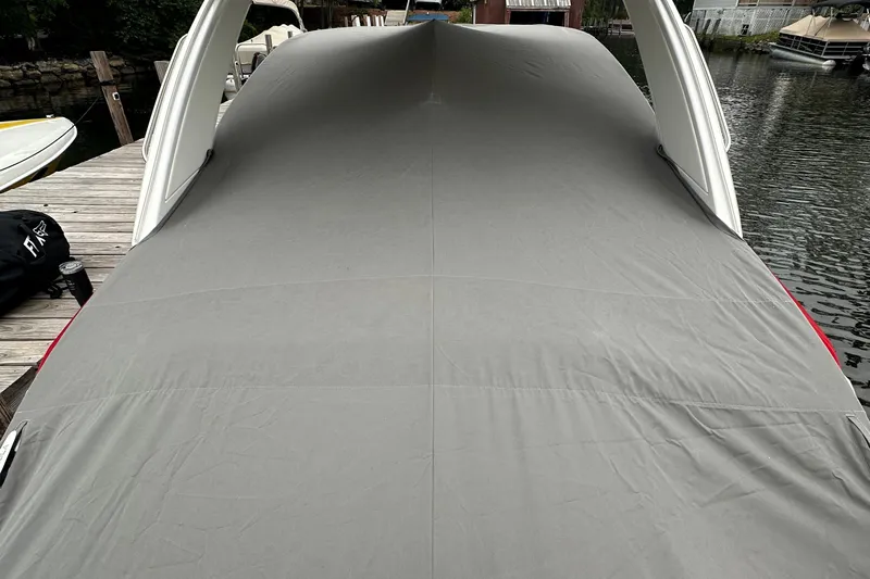  Yacht Photos Pics 2024 Formula 330 CBR boat covered at dockside, showcasing sleek design.