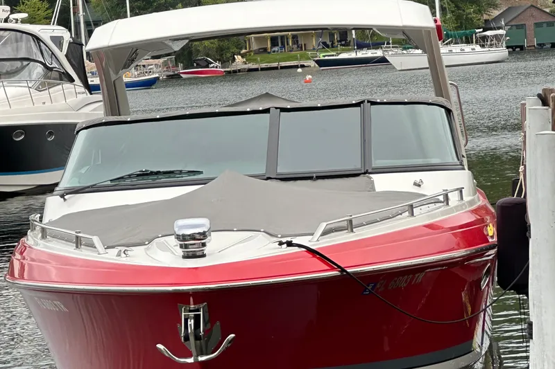  Yacht Photos Pics 2024 Formula 330 CBR boat docked in a marina, featuring a sleek red design.