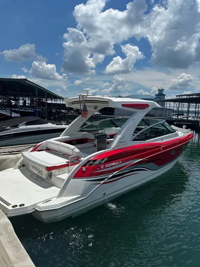  Yacht Photos Pics 2024 Formula 330 Crossover Bowrider I/O in marina, vibrant red and white design.