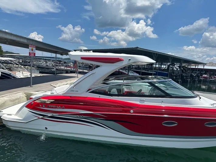  Yacht Photos Pics 2024 Formula 330 Crossover Bowrider I/O in marina, vibrant red and white design.