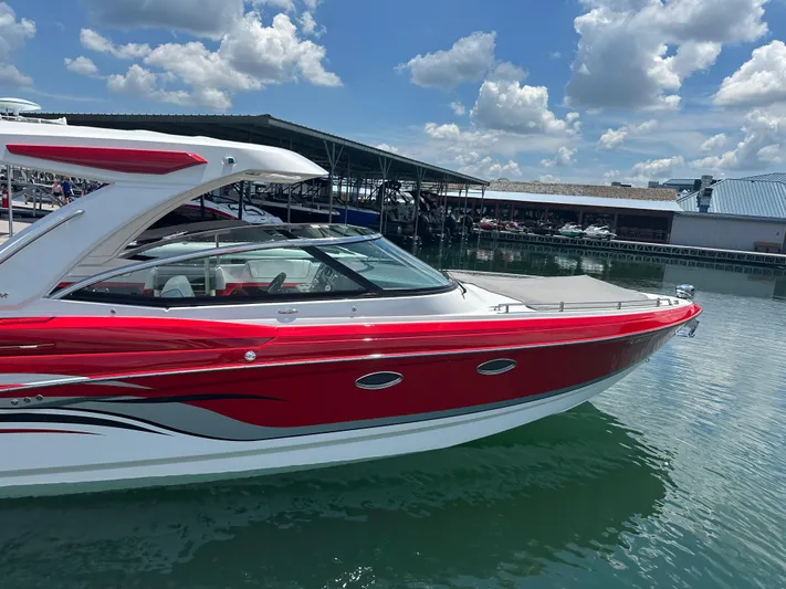  Yacht Photos Pics 2024 Formula 330 Crossover Bowrider I/O in vibrant red, docked under a sunny sky.
