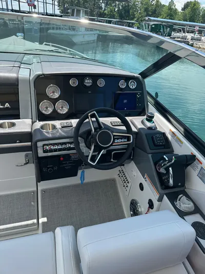  Yacht Photos Pics 2024 Formula 330 Crossover Bowrider I/O dashboard with steering wheel and controls.