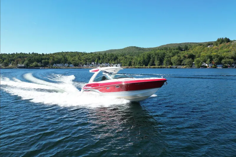  Yacht Photos Pics 2024 Formula 330 Crossover Bowrider cruising on a scenic lake.
