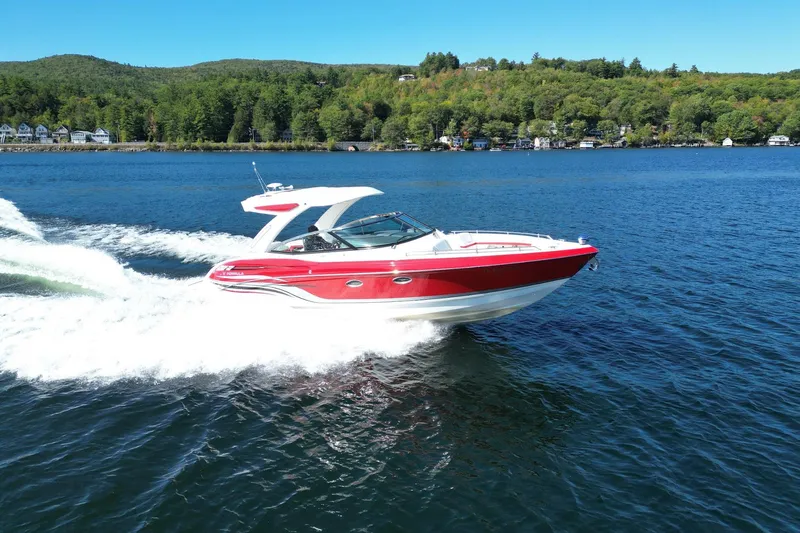  Yacht Photos Pics 2024 Formula 330 Crossover Bowrider cruising on a scenic lake.