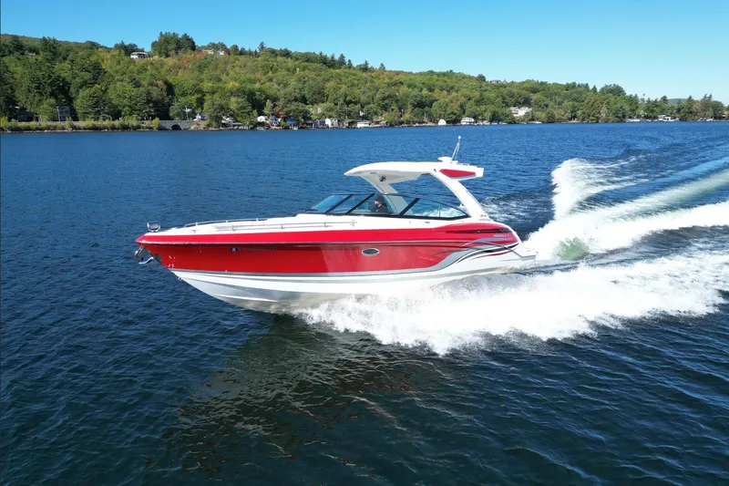  Yacht Photos Pics 2024 Formula 330 Crossover Bowrider cruising on a scenic lake.