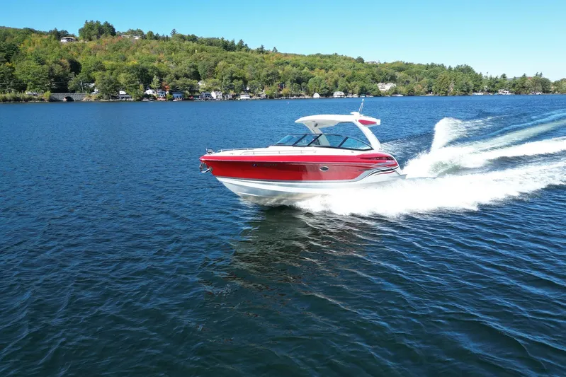  Yacht Photos Pics 2024 Formula 330 Crossover Bowrider cruising on a scenic lake.