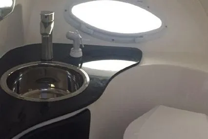  Yacht Photos Pics 2024 Hanover 305 White & Black Edition yacht bathroom with sleek sink and modern fixtures.