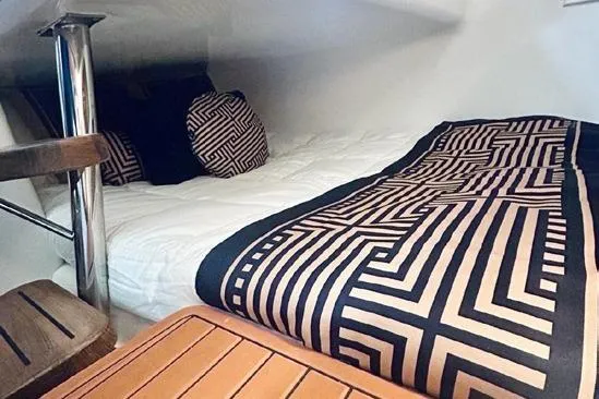  Yacht Photos Pics Cozy cabin interior with geometric bedding in Hanover 305 White & Black Edition, 2024 model.