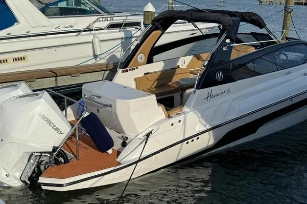  Yacht Photos Pics 2024 Hanover 305 White & Black Edition boat docked with Mercury outboard engine.