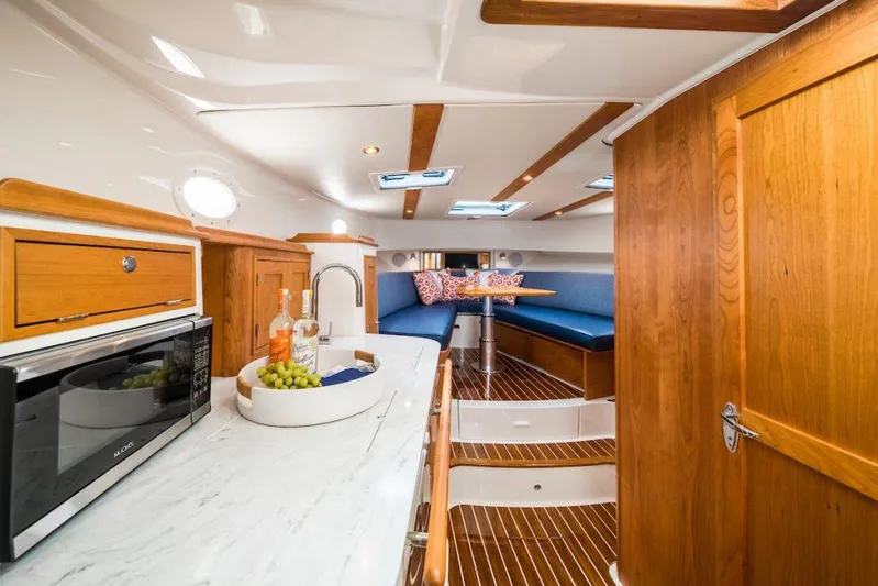  Yacht Photos Pics Manufacturer Provided Image: 2023 Hinckley Sport Boats 40x interior with wooden cabinetry and modern amenities.