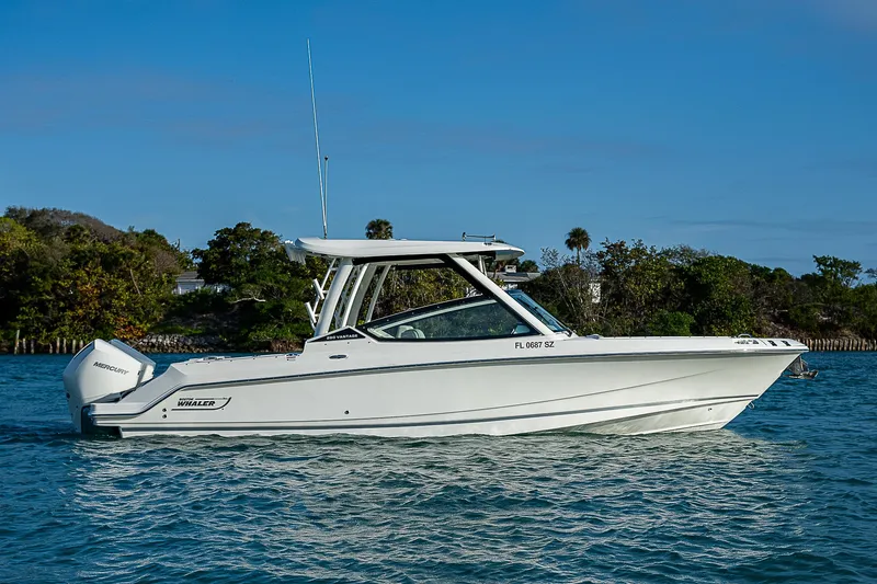  Yacht Photos Pics 2021 Boston Whaler 280 Vantage boat on water, side view, clear sky background.