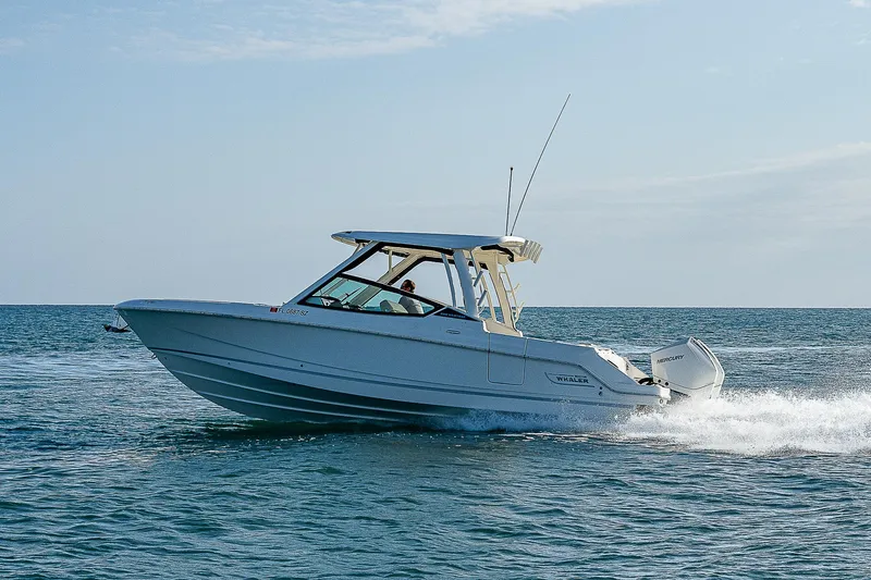  Yacht Photos Pics 2021 Boston Whaler 280 Vantage cruising on open water under clear skies.
