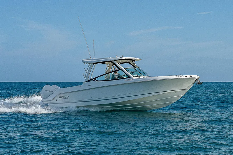  Yacht Photos Pics 2021 Boston Whaler 280 Vantage cruising on open water under clear skies.