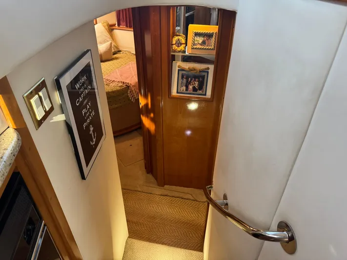  Yacht Photos Pics Interior of 2001 Carver 450 Voyager Pilothouse with cozy bedroom and decorative wall art.