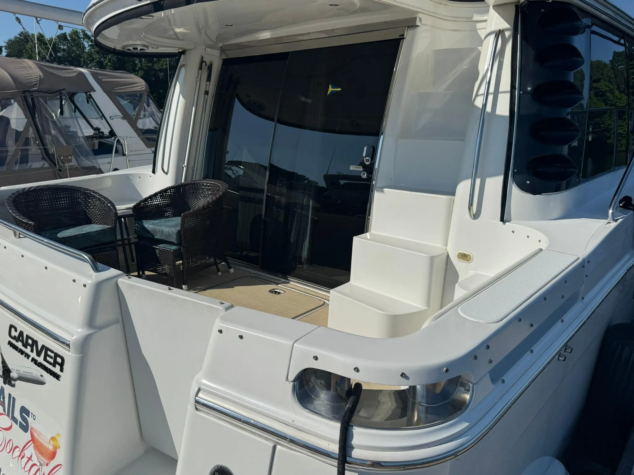2001 Carver 450 Voyager Pilothouse yacht with outdoor seating and sleek design.