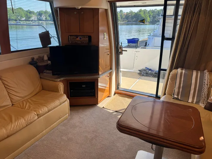  Yacht Photos Pics Interior of 2001 Carver 450 Voyager Pilothouse with cozy seating and waterfront view.