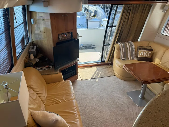  Yacht Photos Pics Luxurious interior of 2001 Carver 450 Voyager Pilothouse with leather seating and a TV.