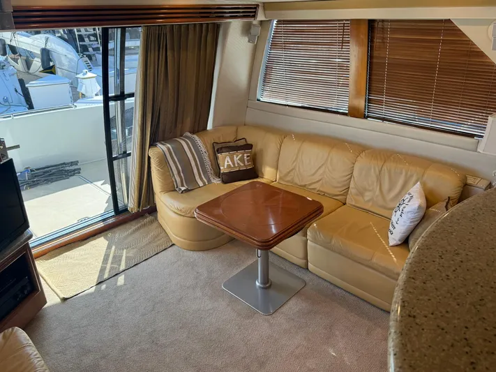  Yacht Photos Pics Interior of 2001 Carver 450 Voyager Pilothouse with leather seating and wooden table.