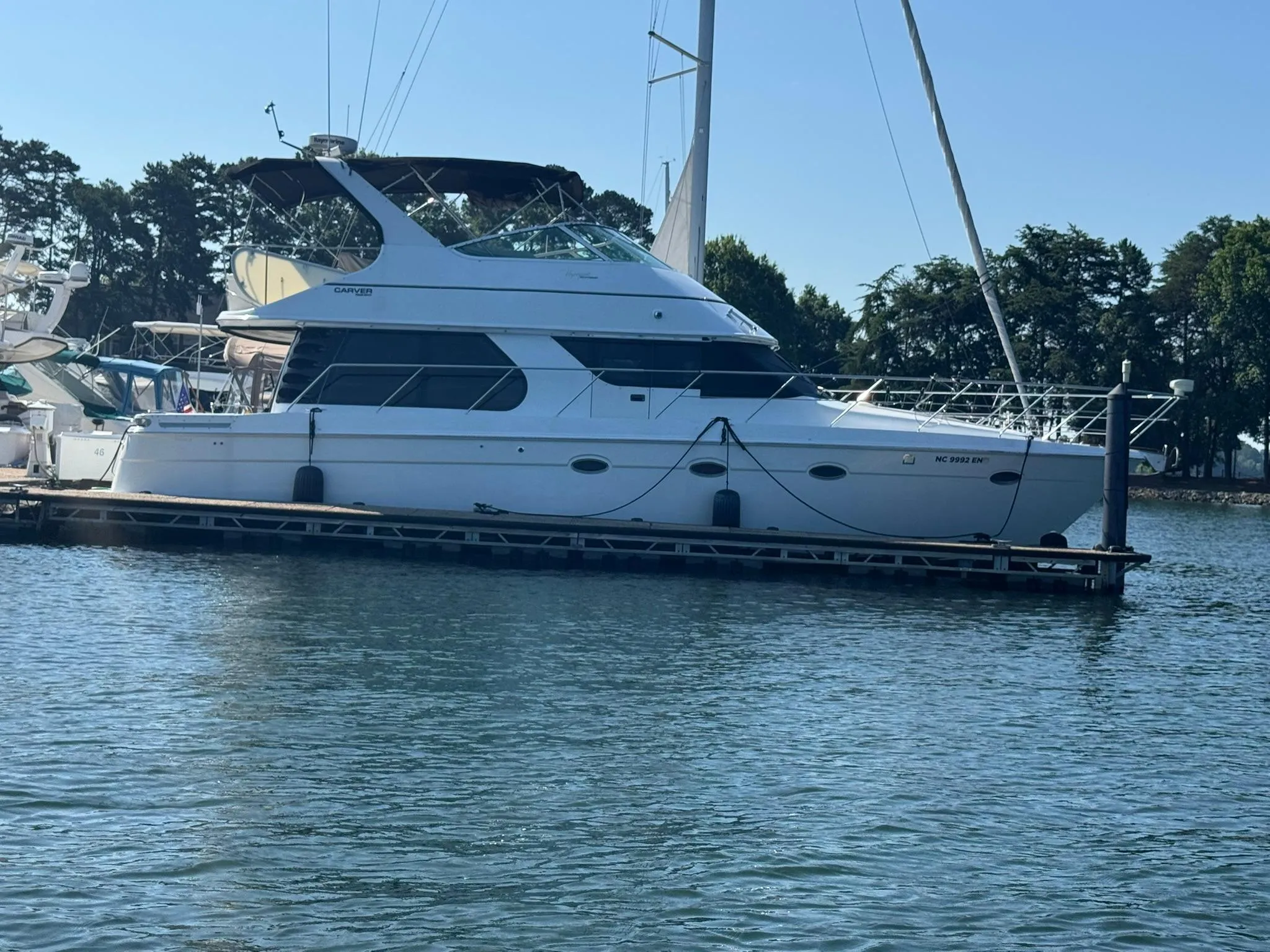 2001 Carver 450 Voyager Pilothouse yacht docked on calm water.