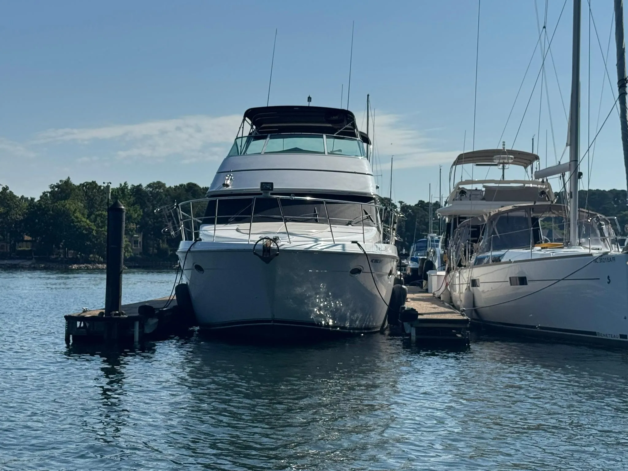 2001 Carver 450 Voyager Pilothouse yacht docked at marina, sunny day.