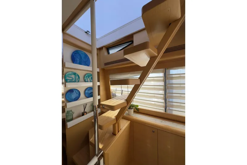  Yacht Photos Pics Interior of 2010 Ferretti Yachts 800 with wooden stairs and decorative blue plates.