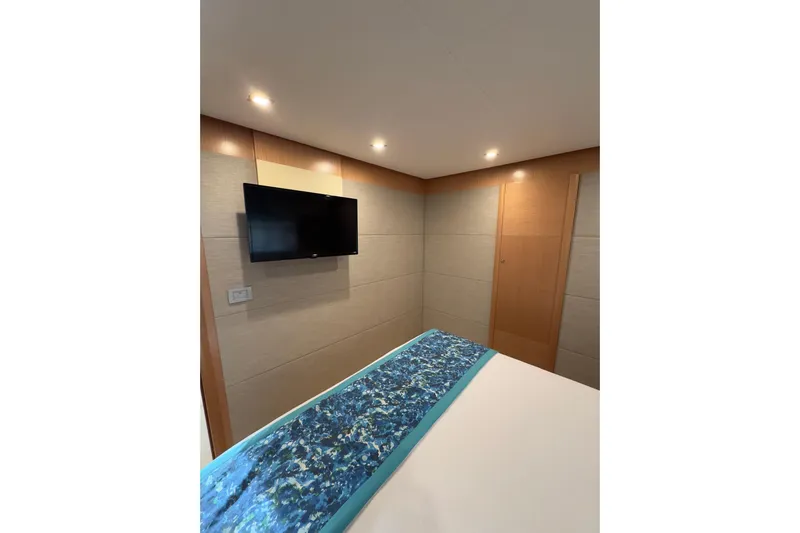  Yacht Photos Pics Luxurious bedroom interior of 2010 Ferretti Yachts 800 with modern TV and elegant decor.