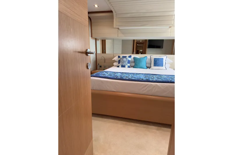  Yacht Photos Pics Luxurious bedroom interior of 2010 Ferretti Yachts 800 with elegant blue accents.