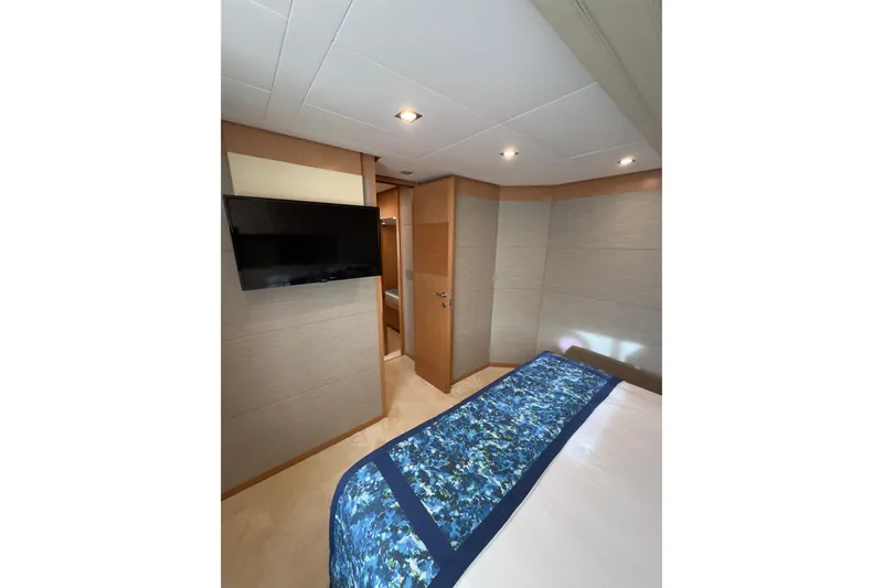  Yacht Photos Pics Luxurious bedroom interior of 2010 Ferretti Yachts 800 with modern decor and flat-screen TV.