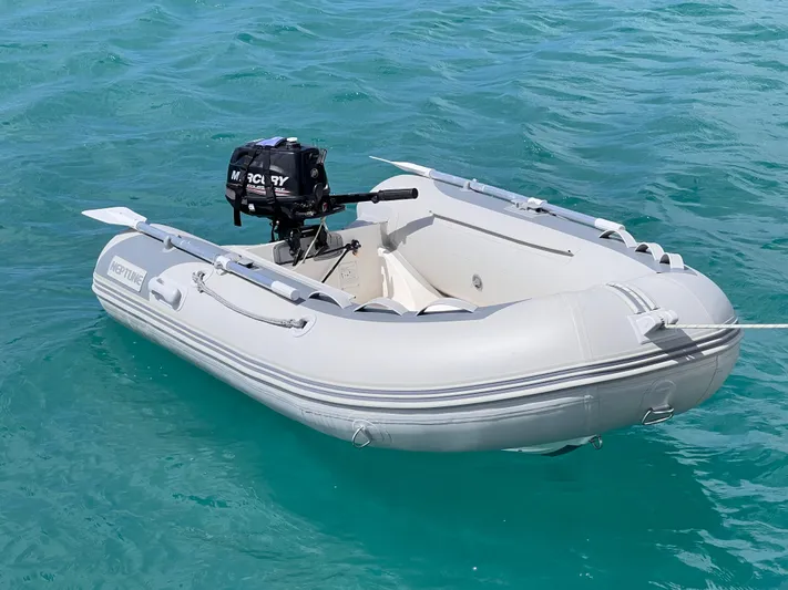 Knotty Nature Yacht Photos Pics Inflatable dinghy with Mercury outboard motor on turquoise water, 2011 Fountaine Pajot Lipari 41.