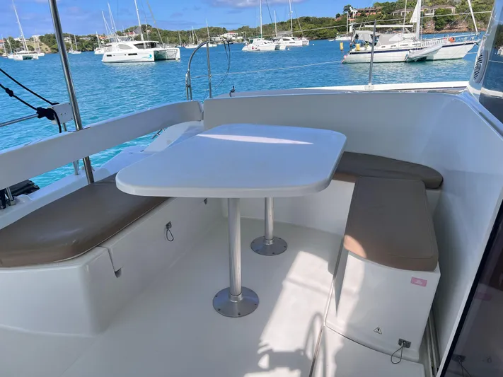 Knotty Nature Yacht Photos Pics Fountaine Pajot Lipari 41 catamaran cockpit with seating and table, 2011 model, docked in marina.