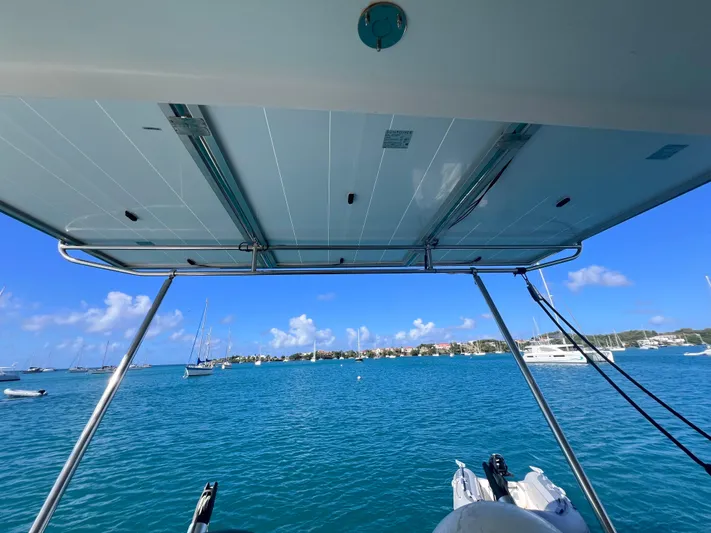 Knotty Nature Yacht Photos Pics View from 2011 Fountaine Pajot Lipari 41 catamaran, overlooking serene blue waters and distant sailboats.
