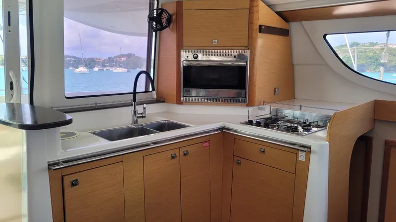 Knotty Nature Yacht Photos Pics Modern kitchen interior of 2011 Fountaine Pajot Lipari 41 catamaran with ocean view.